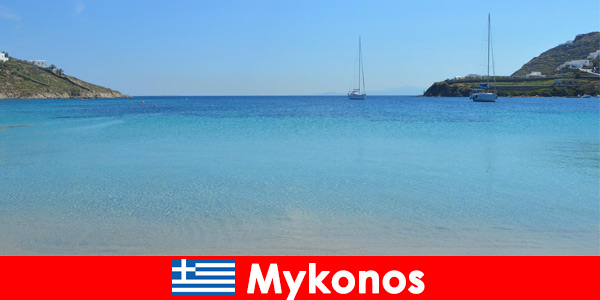 Holidaymakers love the sun and the crystal clear water in Mykonos Greece