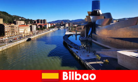 Holidaymakers exploring Bilbao Spain by bike in summer