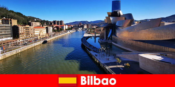 Holidaymakers exploring Bilbao Spain by bike in summer